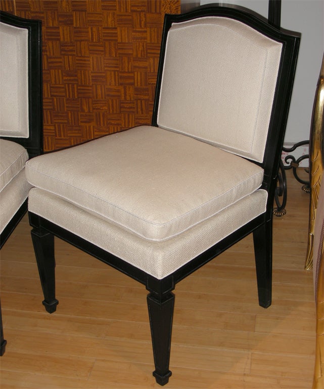 Two 1935 easy chairs in blackwood, with new upholstery. In the style of Jean-Michel Frank.