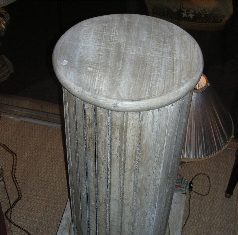 Two 19th century fluted columns in gray patina carved wood. Base has been redone.