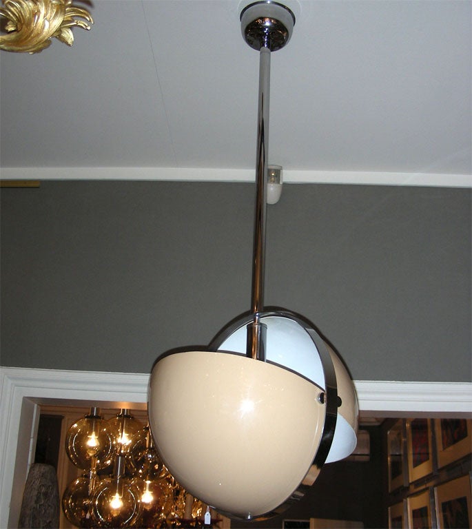1970s Italian ceiling light with a two-shell lacquered tôle shade set in dark lacquered tôle elements.