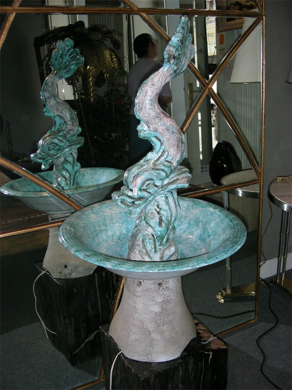 1950s lighted fountain in blue and white enameled faïence by Vallauris. Represents a dolphin spitting water into a round tank set on a pedestal.