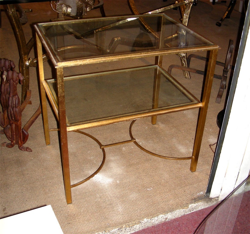 Small 1950-1960 side table in gilt metal with two glass shelves.
Stamped THIBIER