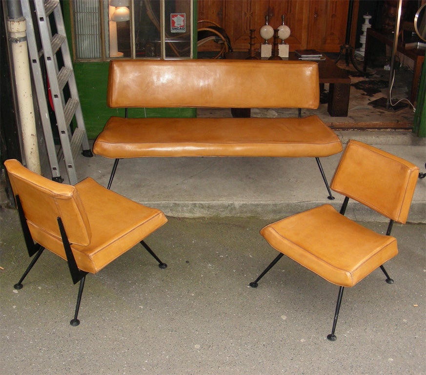 Italian 1960s sofa and two armchairs edited by Velca, Legnano, with black metal base and leather upholstery. Armchairs height 75/40 cm., length 60 cm., depth 65 cm.