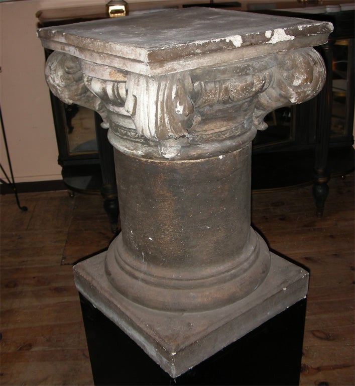 Two 1960s columns in painted stone on a square base and an Ionic type capital.
