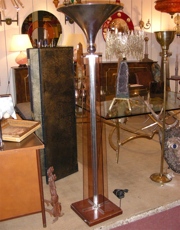 1930s floor lamp by Jacques Adnet, on a wooden base, with shaft in smoked glass and chromed metal. Chromed metal shade.