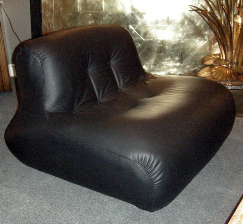 Two 1970-1980 armchairs entirely re-upholstered in leather and set on casters. Wide enough to seat two people.