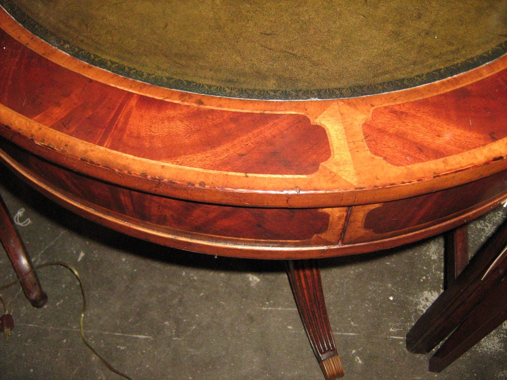 Leather top, pedestal base table with drawer and casters.