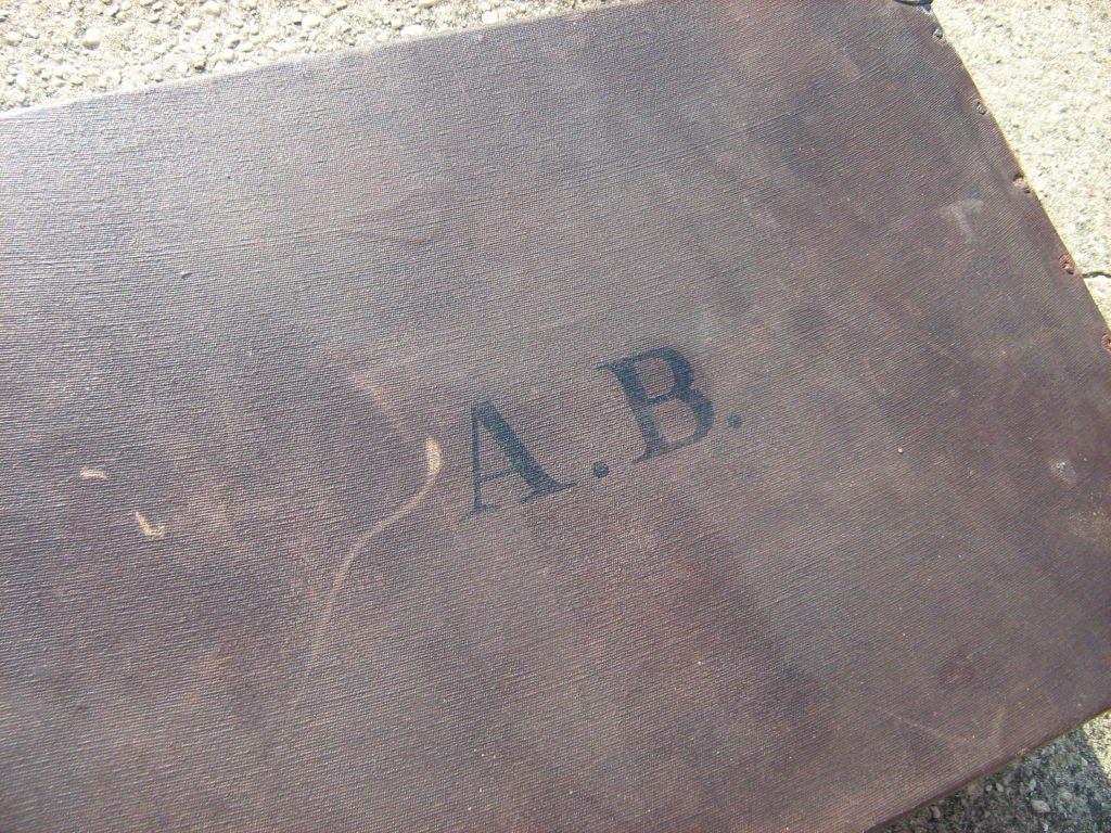 dark brown suitcase with brass corners and wooden strip in the middle.Brass lock, no key.