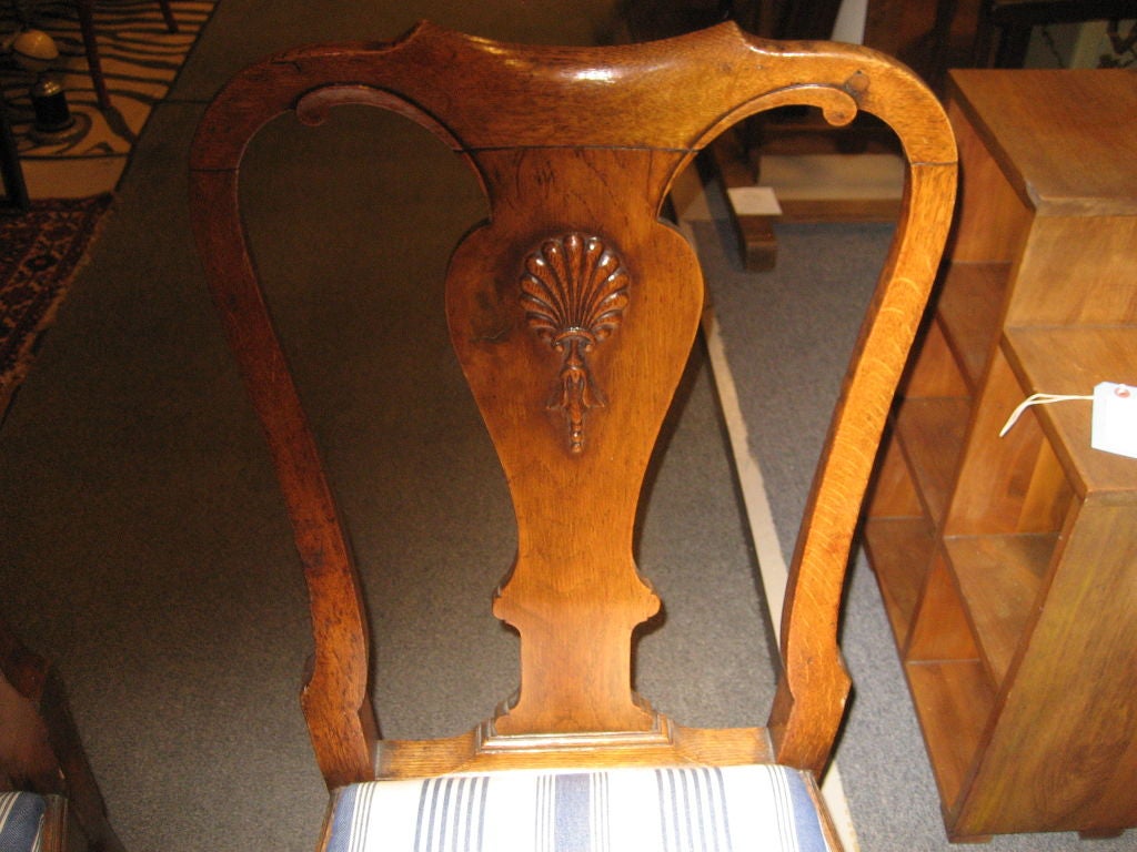 Pair of oak shell motif chairs