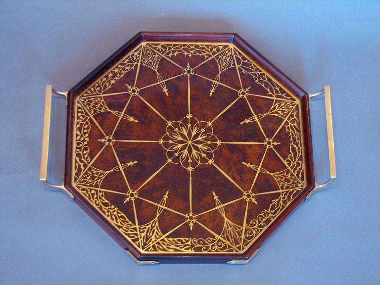 A Viennese Secessionist period octagonal tray executed by Erhard and Sohne in burl wood with brass mounts and inlays of different design in each of the eight sections. Ca. 1905