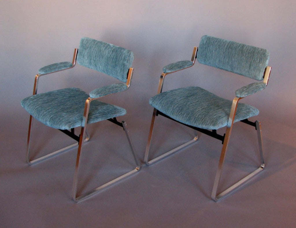 A pair of modernist armchairs executed in aluminium and iron and designed by William Plunkett. Made by William Plunkett Furniture, Ltd.
