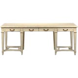 A desk of heroic proportions with a faux-ivory finish.