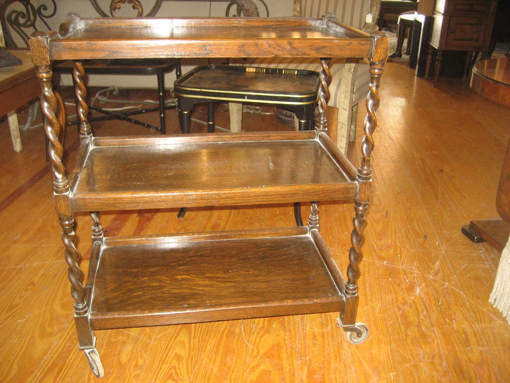 Edwardian Oak Triple-Tiered Tea Trolley, c. 1900, of oblong form, having twist-carved supports and raised on period casters.
