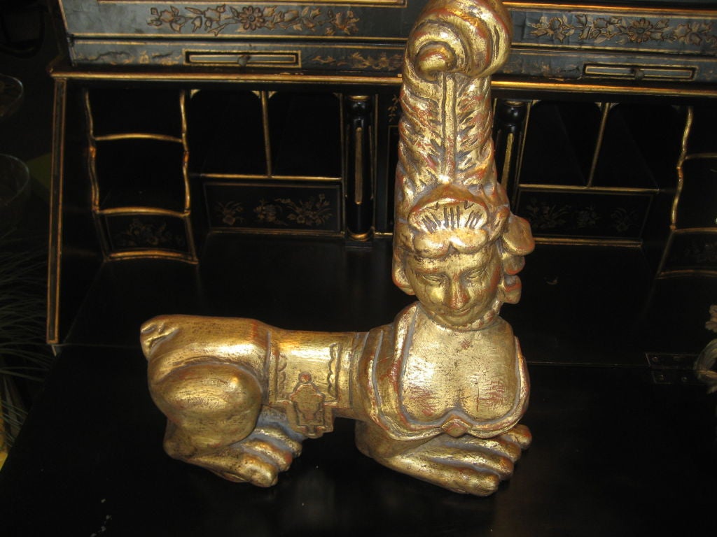 A pair of decorative Gold leaf carved wood sphinxes with a flashed backs. <br />
Can be used as door stoppers or over walls and mirrors