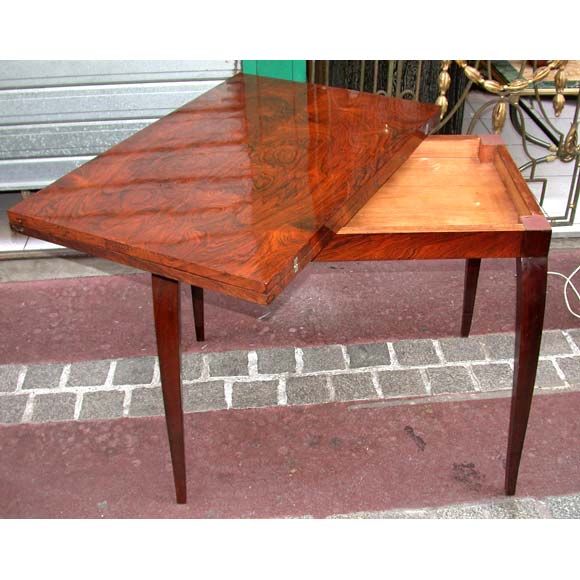 A convertible walnut console table, with tapered legs, brass hooks on both sides, the hinged top plateau opens to double. Full length once opened is 120 cm.