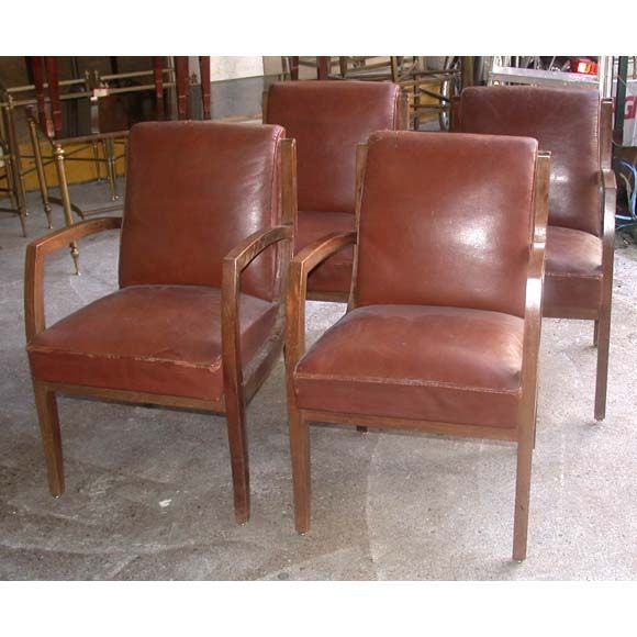 Four mahogany framed bridge chairs attributed to René Prou, the brown leather has signs of age.