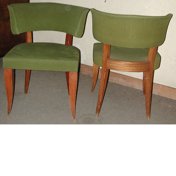 A set of 4 dining chairs in Mahogany stained beech wood with original green fabric, sabre legs and a curved slightly scrolled back