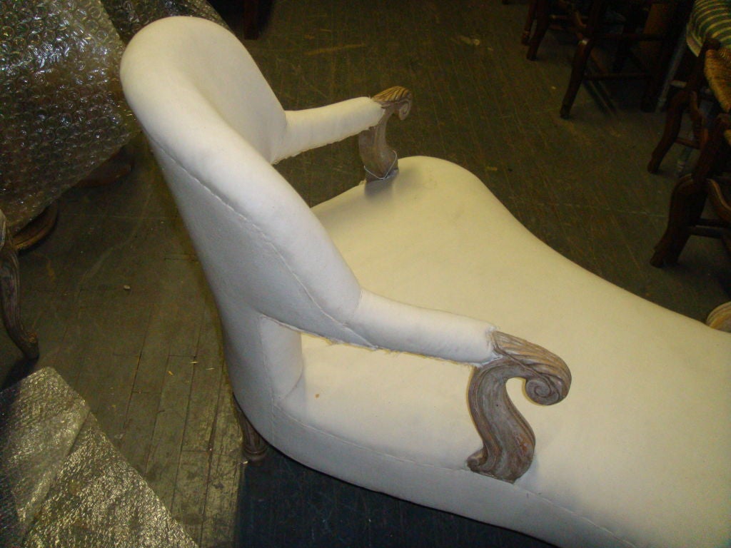 Tête-à-Tête Chair from The David Barrett Collection.  The peice if upholstered in muslin.with nicely carved details on the arms and feet.