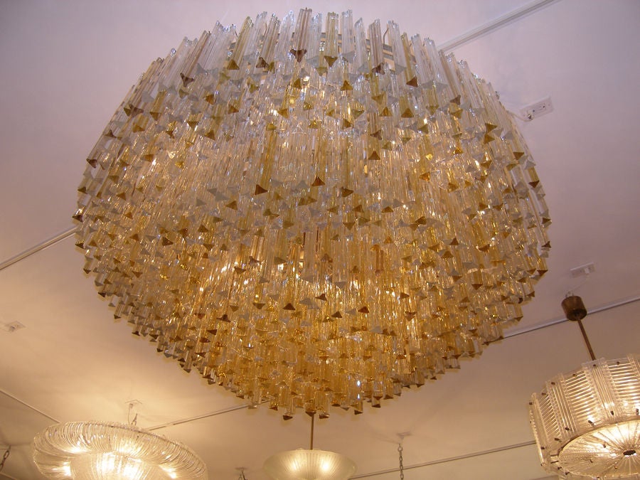 A large three-tiered amber and clear crystal chandelier.

Italian.