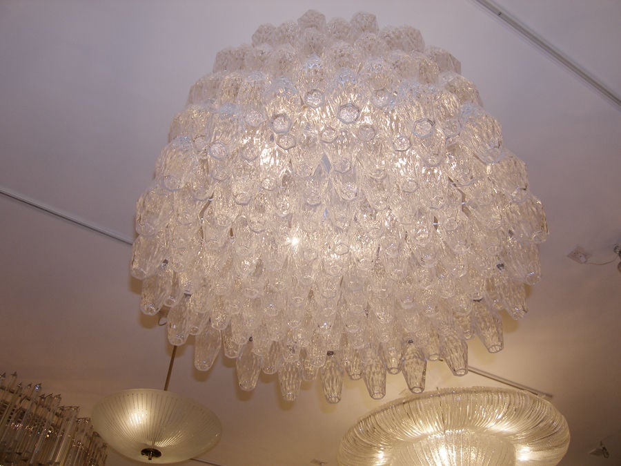 Venini polyhedral clear glass chandelier.

Venini was founded in 1921 in the Italian glass making capital of Murano-- in truth an island in the waters surrounding Venice. Venini is still active to this day producing high quality lighting and