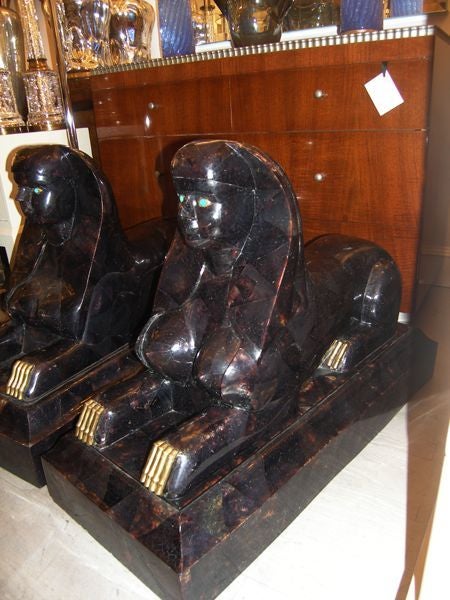 Pair of Large Stone and Bronze Sphinxes with Turquoise Eyes'

In Stock.