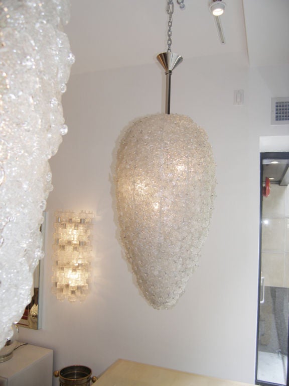 A pair of large Murano chandeliers consisting of multiple glass flowers hung on a metal frame, Italian, late 20th Century

Body of chandelier 36" L x 20" Dia.