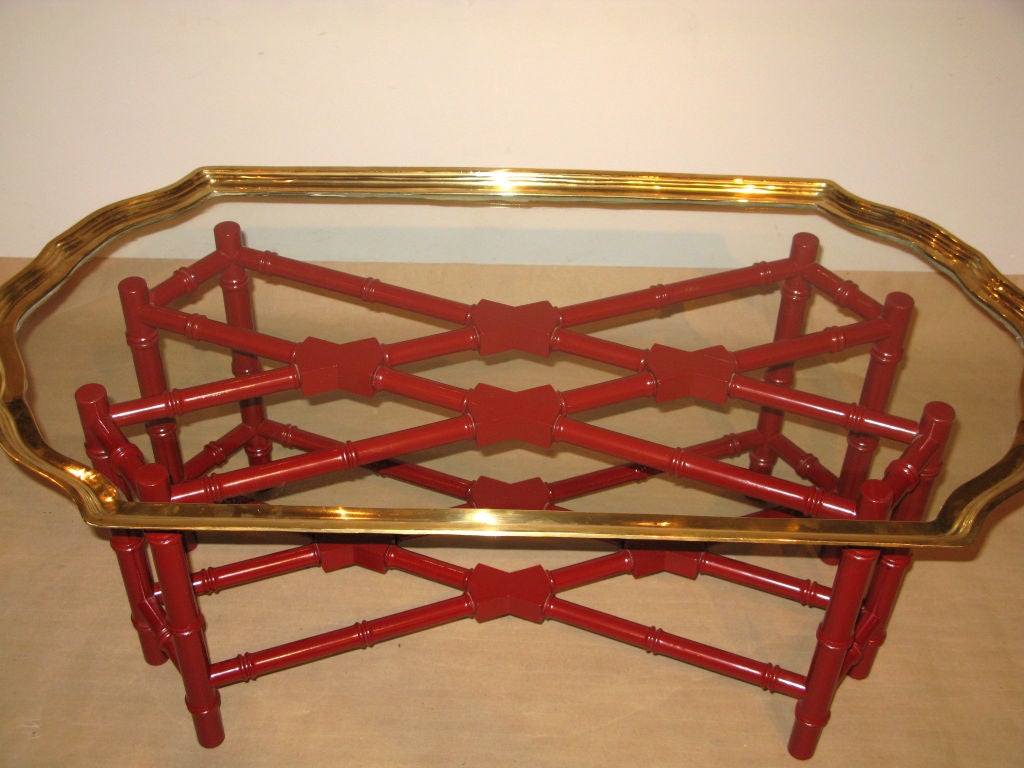 Coffee table with base in red lacquered bamboo and glass tray top finished with brass trim, American 1970's