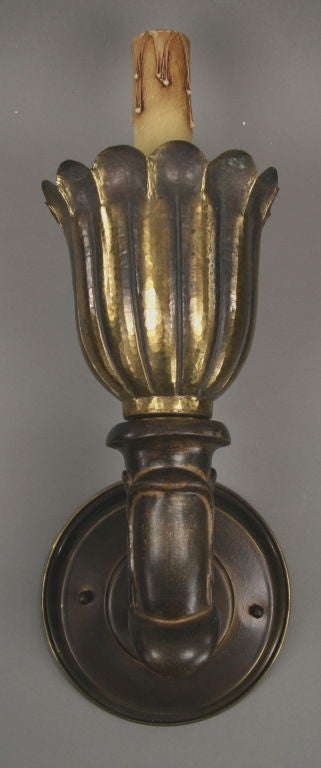 #2-1112 A pair of hammered brass tulip on wood arm single light torchiere sconce.