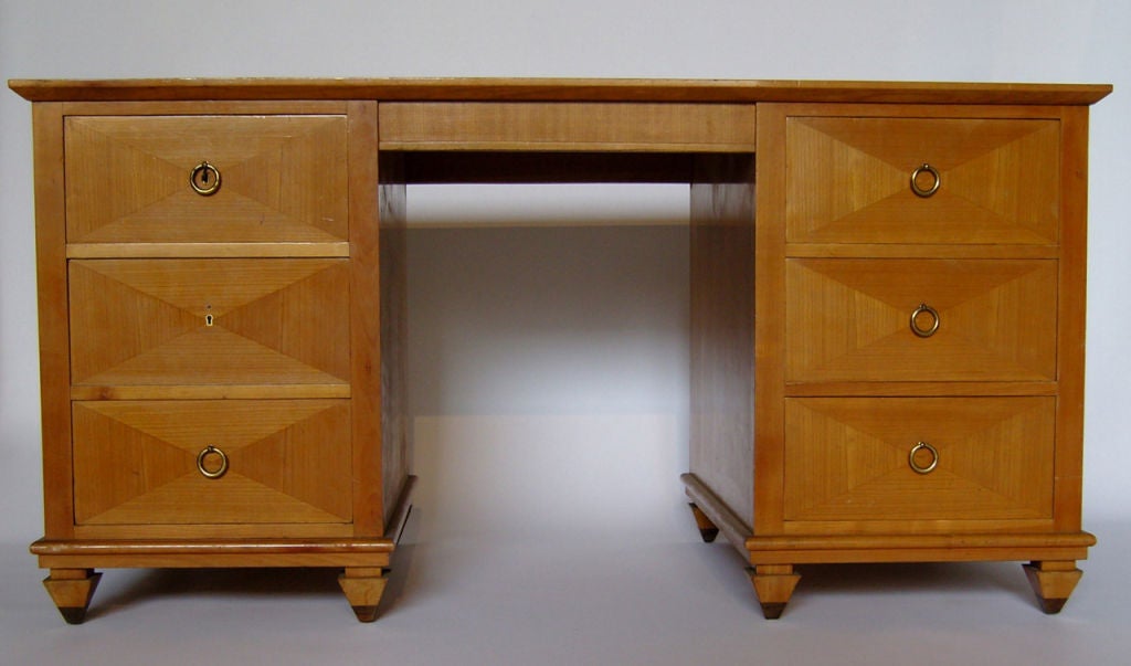 A Fine French Art Deco 6 drawers cherry pedestal desk with a leather top and brass handles.