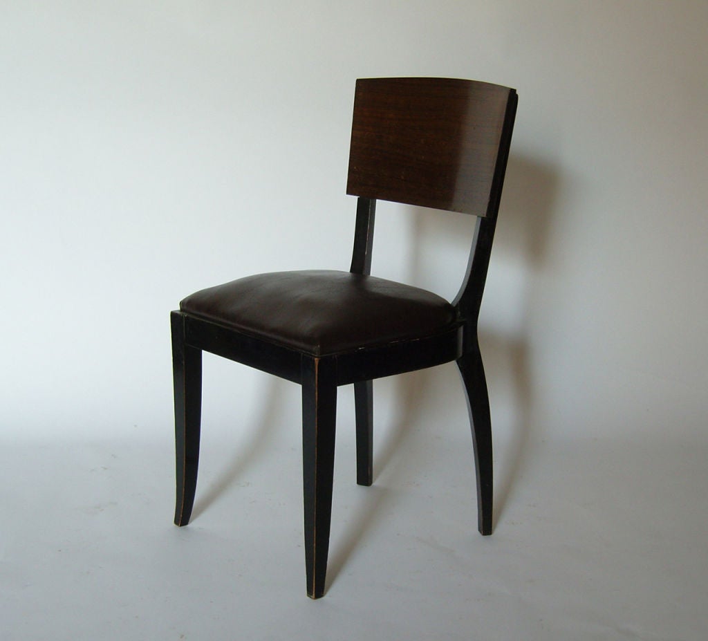 Set of 4 French Art Deco blackened wood dining chairs with a rosewood veneered back rest.