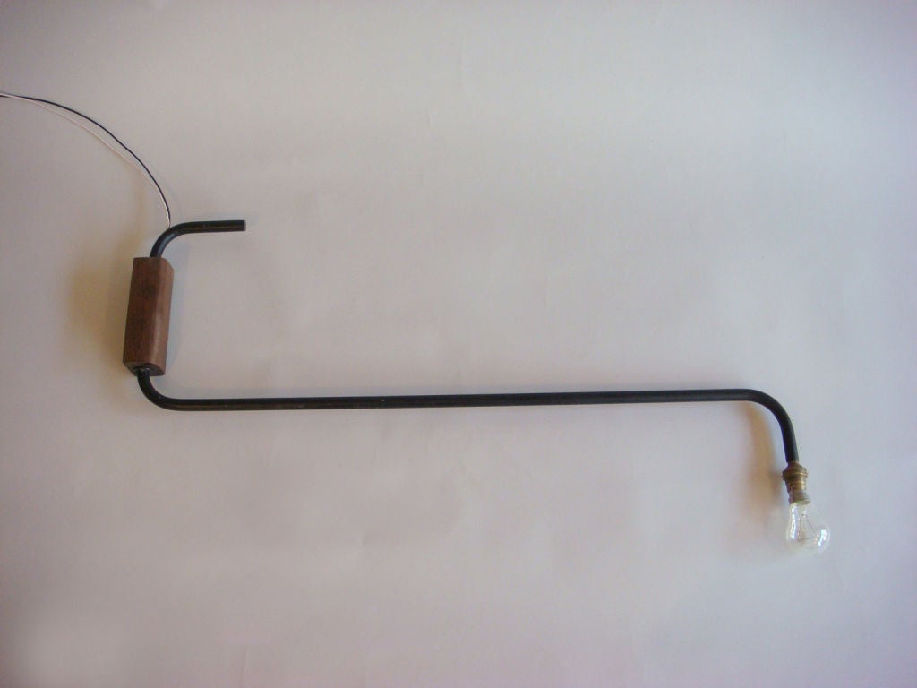 Rare 1940s rotating metal arm wall light/sconce with a solid oak support.