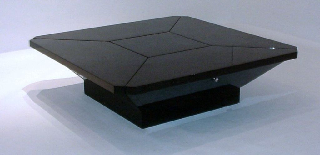 Coffee table in black lacquer.  Four side panels rise on mechanized spring system while center square remains stationary.