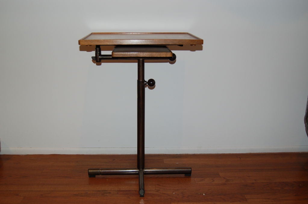Fantastic adjustable side table with 2 tiers. The top table swivels out and tilts. Extension from 26