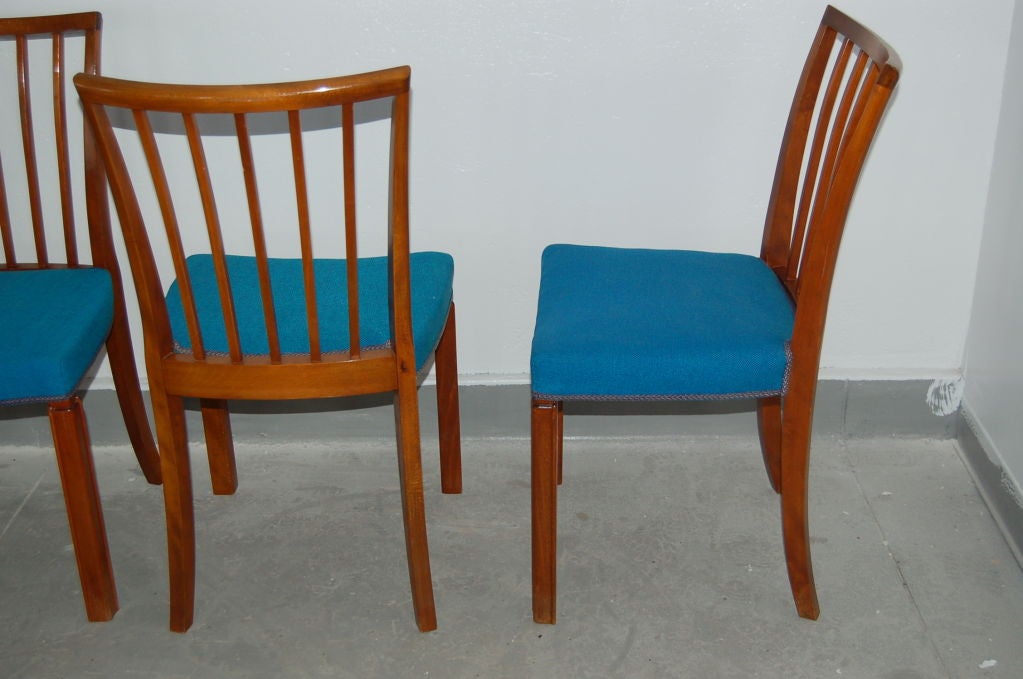 Eight beautiful dining chairs with inset leg detail. Handcrafted in mahogany with original wool seats. 