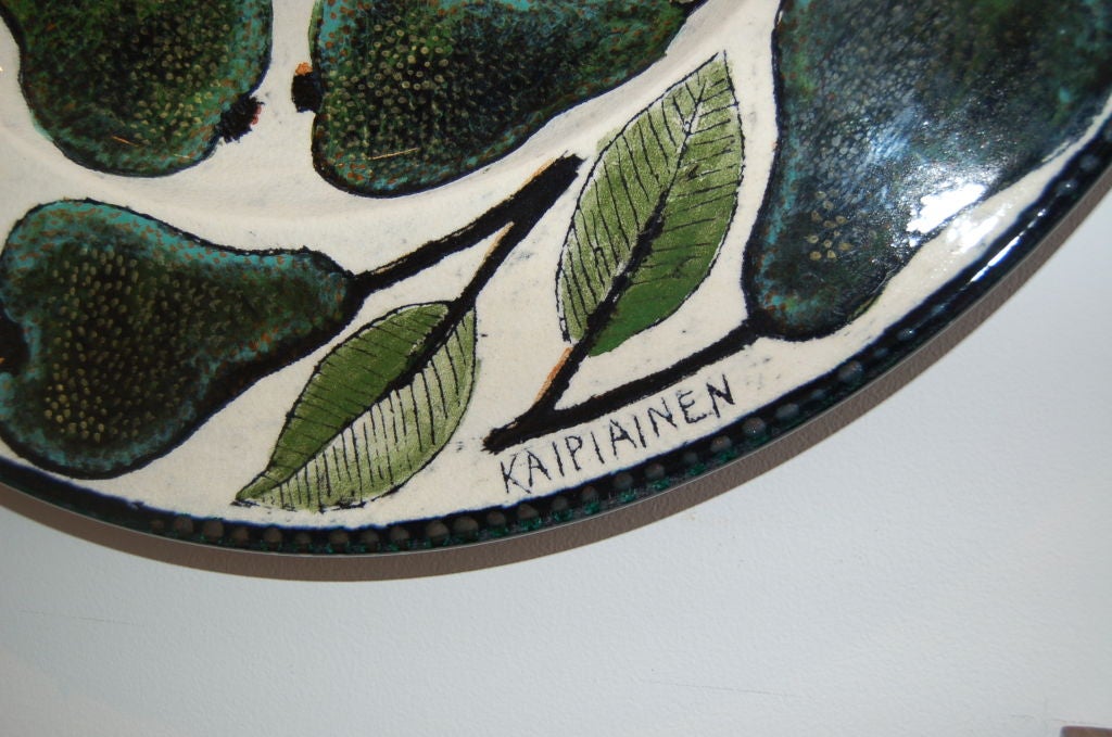 Large round ceramic hanging platter by Birger Kaipiainen for Arabia, Finland. Green pears and leaves in painted pattern. Signed Kaipiainen.