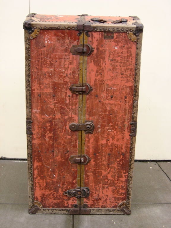Extraordinary wardrobe trunk with japanned hanging rods that swivel into any position and the stow away.