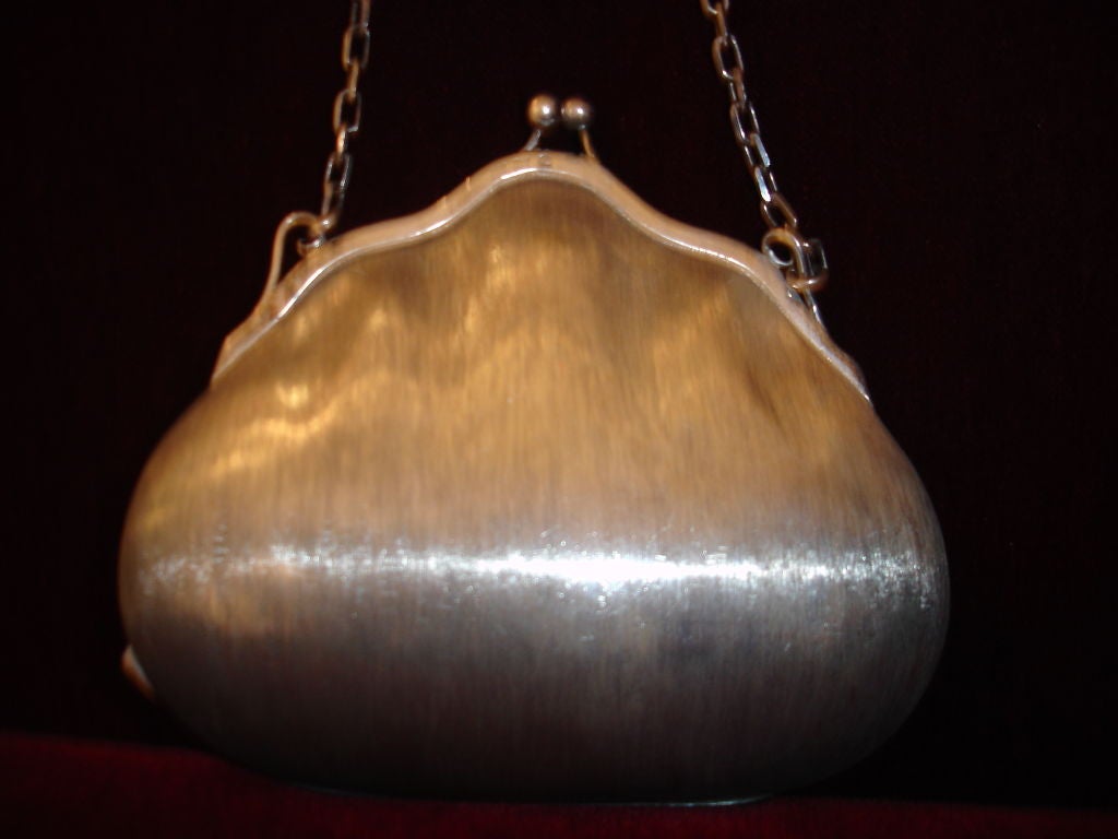 A rare and unusual evening purse of 925 silver signed and hallmarked by Gucci. Formed in a shape similar to a clam shell and fitted with a pale pink velvet.