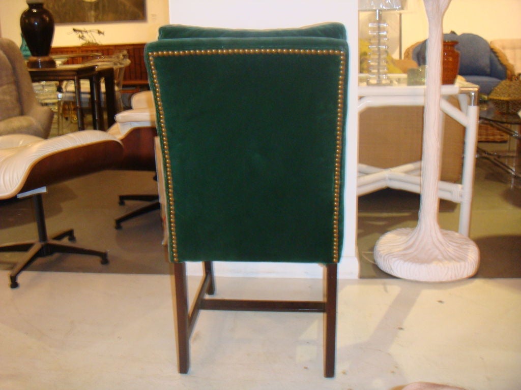 A set of 8 dining chairs consisting of 2 sides and 6 sides. Great design. Chairs have an asian modern appeal and are in the style of Harvey Probber or even Dunbar. Nicely upholstered in a hunter green velvet and finished with brass studs. Vey