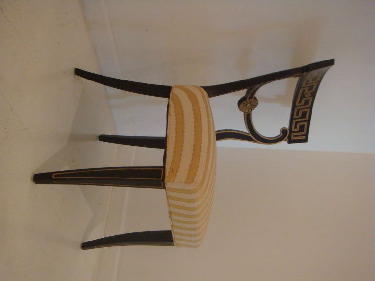 A set of 4 neoclassical chairs by Richard Plummer. Chairs ave black frames and accented with a gilded greek key pattern.