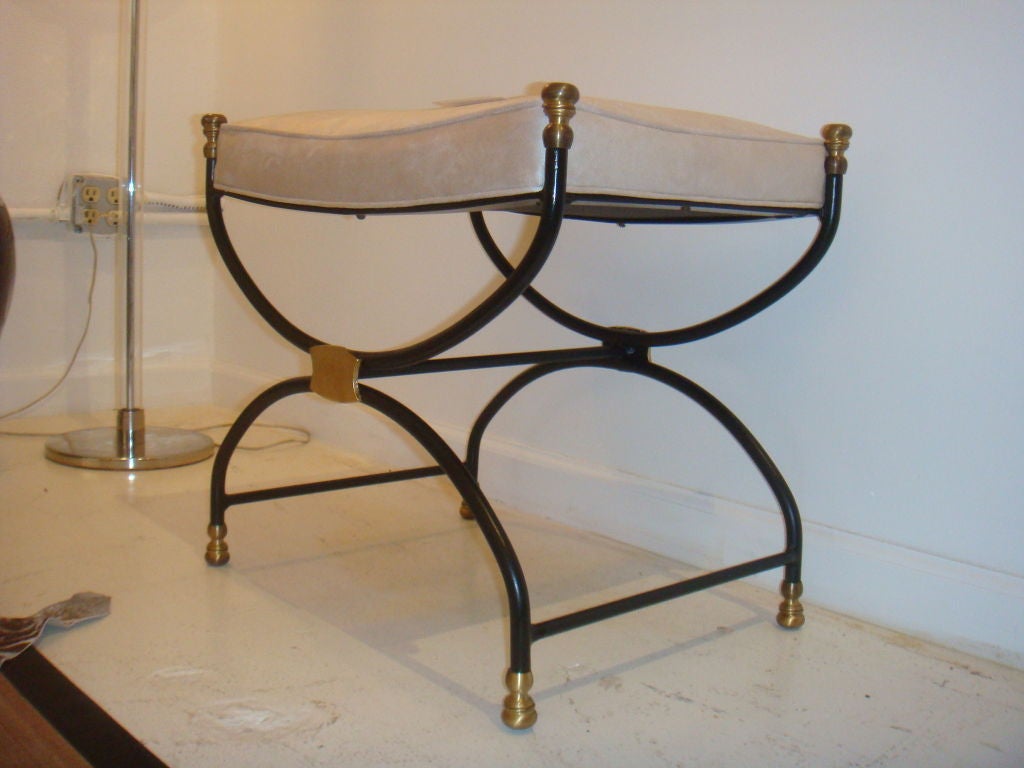 Simpy Chic pair of benches of black iron and brass. The pair are a great combination of black iron highlighted with bras accents. This pair of benches have a classic yet modern elegance too them.