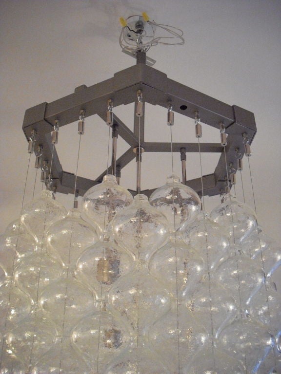A great large chandelier composed of an iron frame 24 strands of blown glass tulipan balls. Made by famed Austrian lighting company, Kalmar.