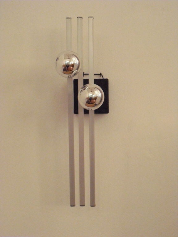 A great pair of 1980s modular Art-tech style sconces by famed Italian light maker, Esperia. They have two light sources are have a brushed chrome finish. Original label. Sale price noted.
