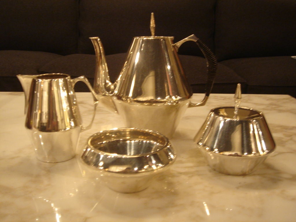 Four-piece Tea serving set in sterling silver designed by Gio Ponti for Reed & Barton in the Diamond pattern. USA, circa 1950. <br />
<br />
Includes a tea pot, creamer, sugar jar and waste pot. Tea pot and sugar jar are lidded. Tea pot features