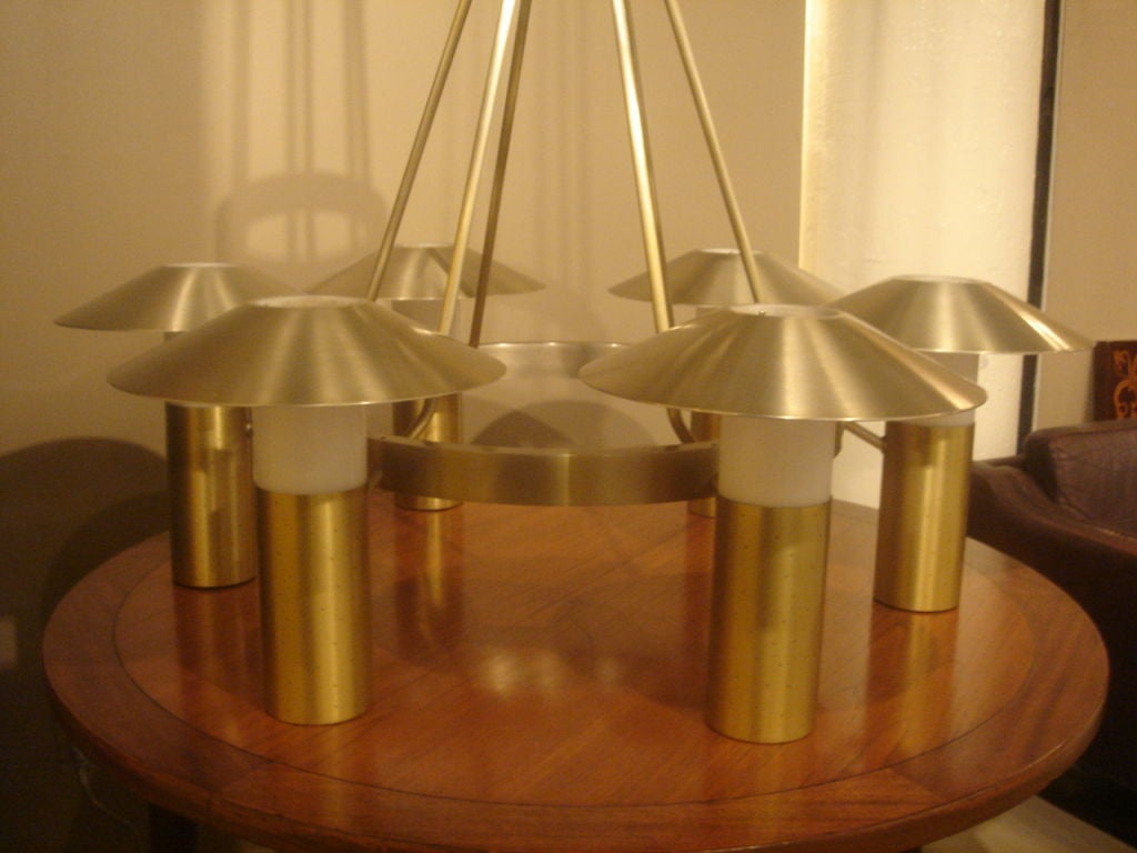 Monumental brushed aluminum chandelier in brushed brass finish.  USA, circa 1950.  Features six arms with white diffuser and brushed aluminum shades.  Each arm holds both an up and down light bulb.  <br />
<br />
Measures 48