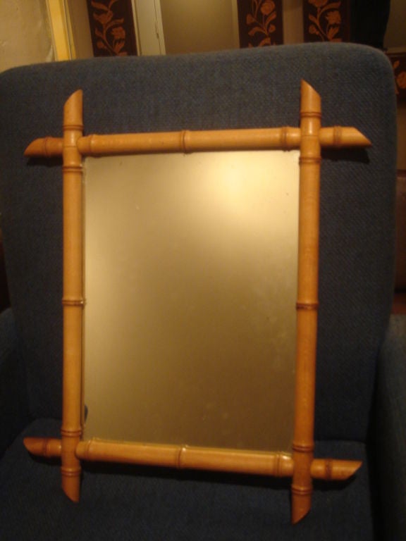 Vintage bamboo mirror.  USA, circa 1970.  Mirror with original bambook frame.

Measures overall 16.25