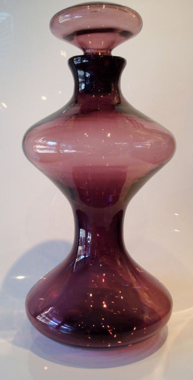 Rare, large mushroom decanter in amethyst glass by Wayne Husted for Blenko. Hourglass shape with original stopper in highly desirable amethyst color, Model 5719.<br />
Documented in Blenko catalog, 1958, page 11.