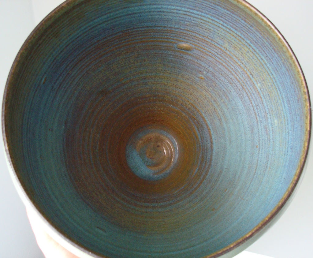 Early bowl by Edwin and Mary Scheier. Incised with fish motif. Glazed in celadon and blue. Interior fully glazed. Minor hairline crack has been stabilized by conservator.