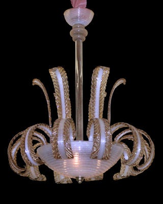 A WHIMSICAL ITALIAN 1940'S HAND-BLOWN RIBBED, BUBBLED (PULEGOSO) CLEAR AND AMBER GLASS FEATHER CIRCULAR CHANDELIER. The domed concentrically ribbed canopy suspending the shaft of turned hand-blown glass elements; above the large similarly ribbed