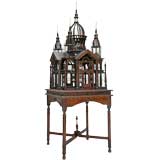 AN ENGLISH COLONIAL MAHOGANY BIRDCAGE ON STAND