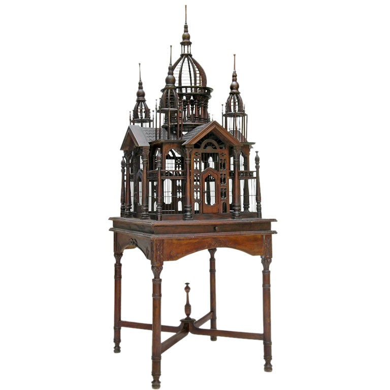 AN ENGLISH COLONIAL MAHOGANY BIRDCAGE ON STAND