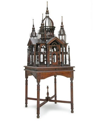 AN ARCHITECTURAL ENGLISH COLONIAL MAHOGANY QUADRANGULAR BIRDCAGE AND STAND WITH LATER ALLIGATOR LINING TO REMOVABLE TRAY.The quadrangular openwork structure; with a peaked cruciform roof with a central domed cupola raised on a circular colonnade;